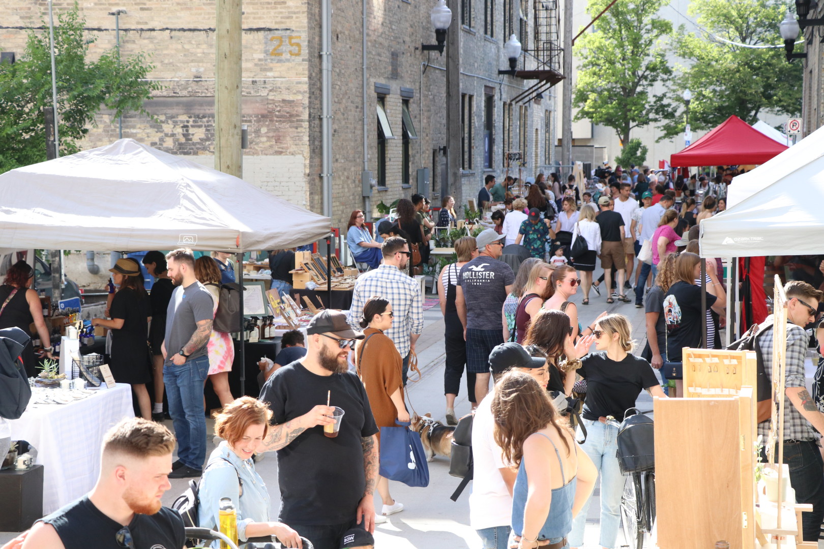 Crowd of people exploring Alleyways Market at the Elgin Alley in the Exchange District, Winnipeg